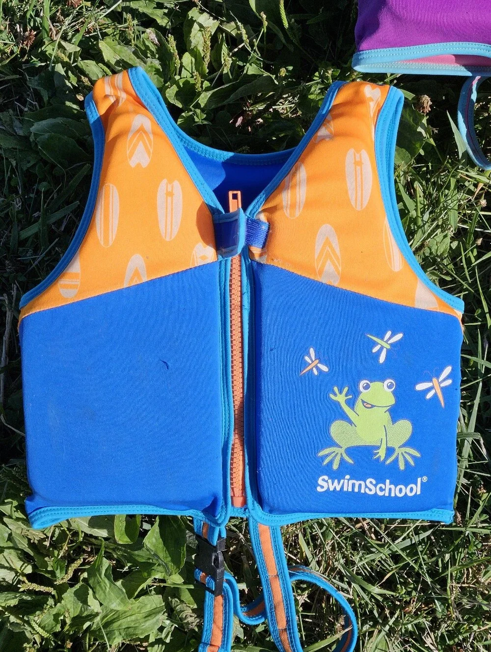 SwimSchool kids life jackets in blue/orange with white chevron pattern and green